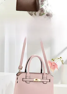 Detail of luxury textured leather handbag with gold lock and adjustable shoulder strap