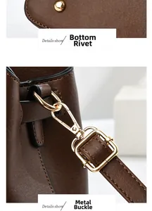 Detail of golden rivets on bag base and lobster clasp hardware for leather handbag