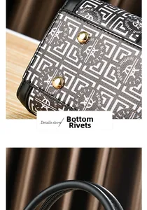 Detail der goldenen Bodennieten und der glatten Ledergriffe einer Boston Bag