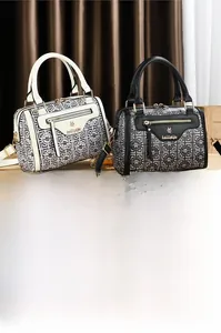 Detailed view of Boston bags in black and white with textured patterns and gold hardware