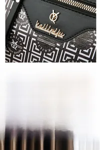 Close-up of black embossed Boston bag featuring gold metal zipper and detailed texture