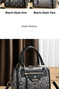 Detail view of black Boston bag with monogram and geometric patterns with dual straps