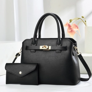Luxurious black pebbled leather tote bag with matching envelope wallet and gold hardware
