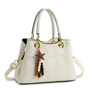 Minimalist beige tote bag with geometric embossing and star charm on white background