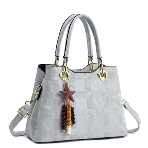 Light gray embossed tote bag with geometric patterns, twin handles and star charm