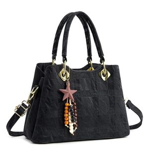 Elegant black quilted tote bag with golden hardware and star beaded charm detail