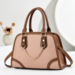 Elegant beige pebbled leather handbag with dark brown handles and golden chain detail