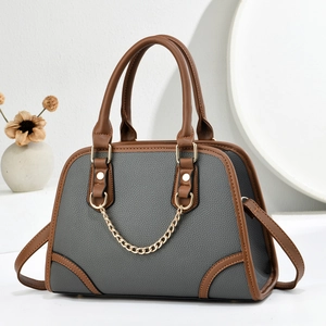 Elegant grey and brown leather shell handbag with gold chain detail and crossbody strap