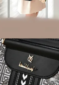 Detail view of black leather bag with gold logo and geometric patterned strap