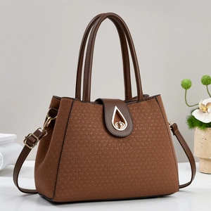 Brown handbag with V-textured surface, gold water-drop clasp and adjustable strap