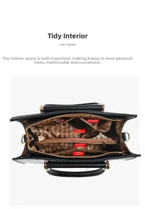 Detailed interior of black leather handbag with striped lining and multiple compartments