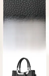 Macro shot of black pebble grain leather texture with silver metal hardware accents