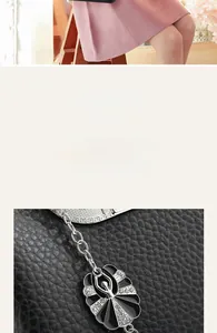 Detail of ballerina bag charm with rhinestones on black lychee pattern leather