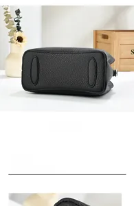 Detail view of the reinforced black lychee pattern leather base with smooth stitching