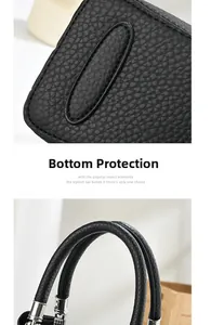 Detail of lychee textured leather handbag with protective bottom feet and silver metal hardware
