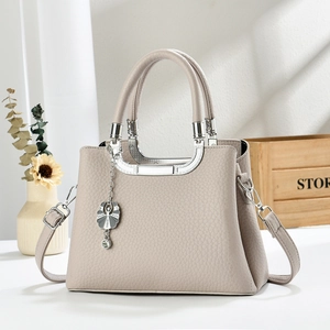 Elegant apricot crossbody handbag with lychee pattern leather and silver metal handles