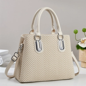 Chic herringbone weave tote bag with cream leather trim and adjustable shoulder strap