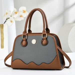 Elegant grey and brown leather tote bag with wavy stitching and golden hardware