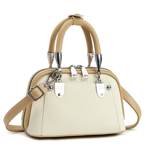 Detail showing beige crossbody bag with double zippers and silver metal hardware