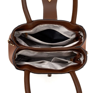 Macro view of the multi-compartment interior and herringbone lining of this large tote bag