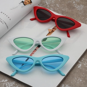 Close-up of cat-eye sunglasses in red, white and blue colors on a fashion magazine