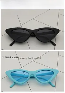 Detail of vintage cat-eye sunglasses in shiny black and sky blue plastic frames