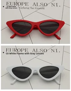 Close-up of cat-eye sunglasses in red and white frames with dark gray lenses