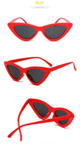 Vue détaillée des lunettes de soleil œil-de-chat rouges avec charnières métalliques et verres
