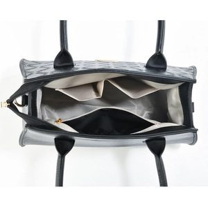 Internal view of the black tote bag showing compartments and herringbone fabric lining