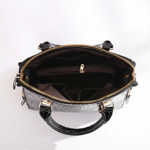 Top view of black crocodile pattern bag showing multiple interior storage compartments