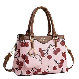 Pink cherry print handbag with brown handles, shoulder strap and mini coin purse accessory