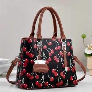 Large capacity black handbag with red cherry print and brown leather handles