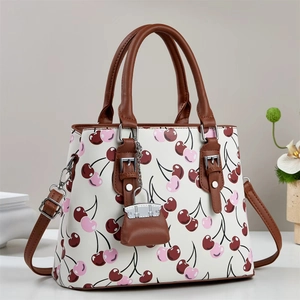 Fashionable cherry print shoulder bag with brown trim and metallic buckle accents