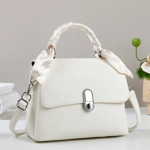 White lychee leather tote bag with silk scarf handle and metal clasp on neutral background