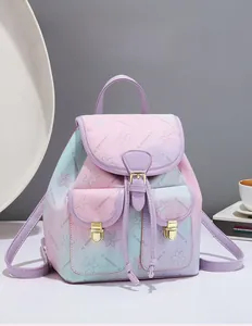 Detail of floral gradient backpack showing golden metal buckles and front pockets