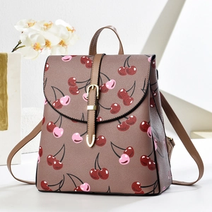 Taupe PU leather backpack with red cherry pattern and golden buckle on white background