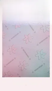 Detail of gradient cross-grain leather texture with embossed floral and arrow patterns
