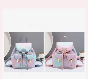 Detail of pink and blue gradient backpacks with star prints and gold metal buckles