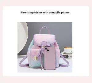Mini floral gradient backpack shown next to a smartphone for size scale reference