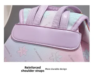 Close-up of reinforced shoulder strap stitching on a floral gradient fashion backpack