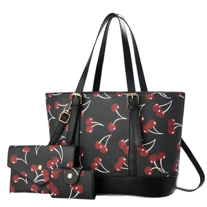 Three-piece black tote bag set with red cherry print including wallet and small pouch