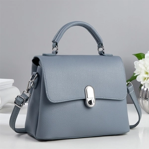 Elegant mist blue litchi leather flap bag with silver clasp and top handle for women