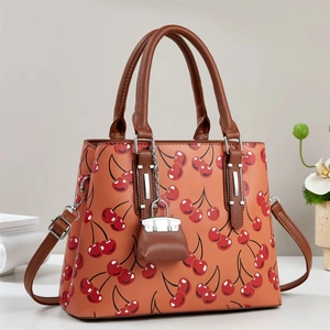 Fashionable caramel orange tote bag with cherry print and adjustable long shoulder strap