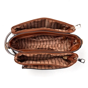 Detailed interior of deep brown crossbody bag with three zipper compartments and striped lining