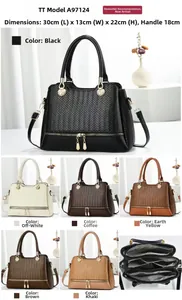 Detail view of woven leather handbag with dual zippers and adjustable shoulder strap