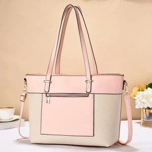 Close-up of pink and beige woven tote bag with adjustable shoulder strap and zip pocket