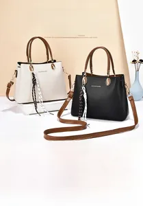 Close-up of premium pebbled leather handbags with golden hardware and striped ribbon detail