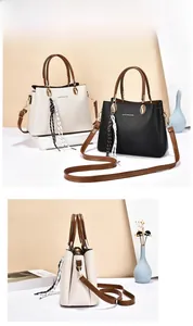 Detail view of large soft leather tote with three compartments and silk scarf accent