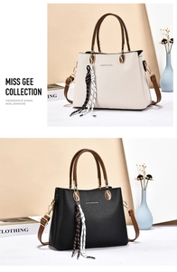 Detail view of large soft faux leather tote bags in white and black with pebble texture