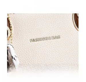 Detail of lychee pattern beige leather texture with golden fashion logo and metal chain
